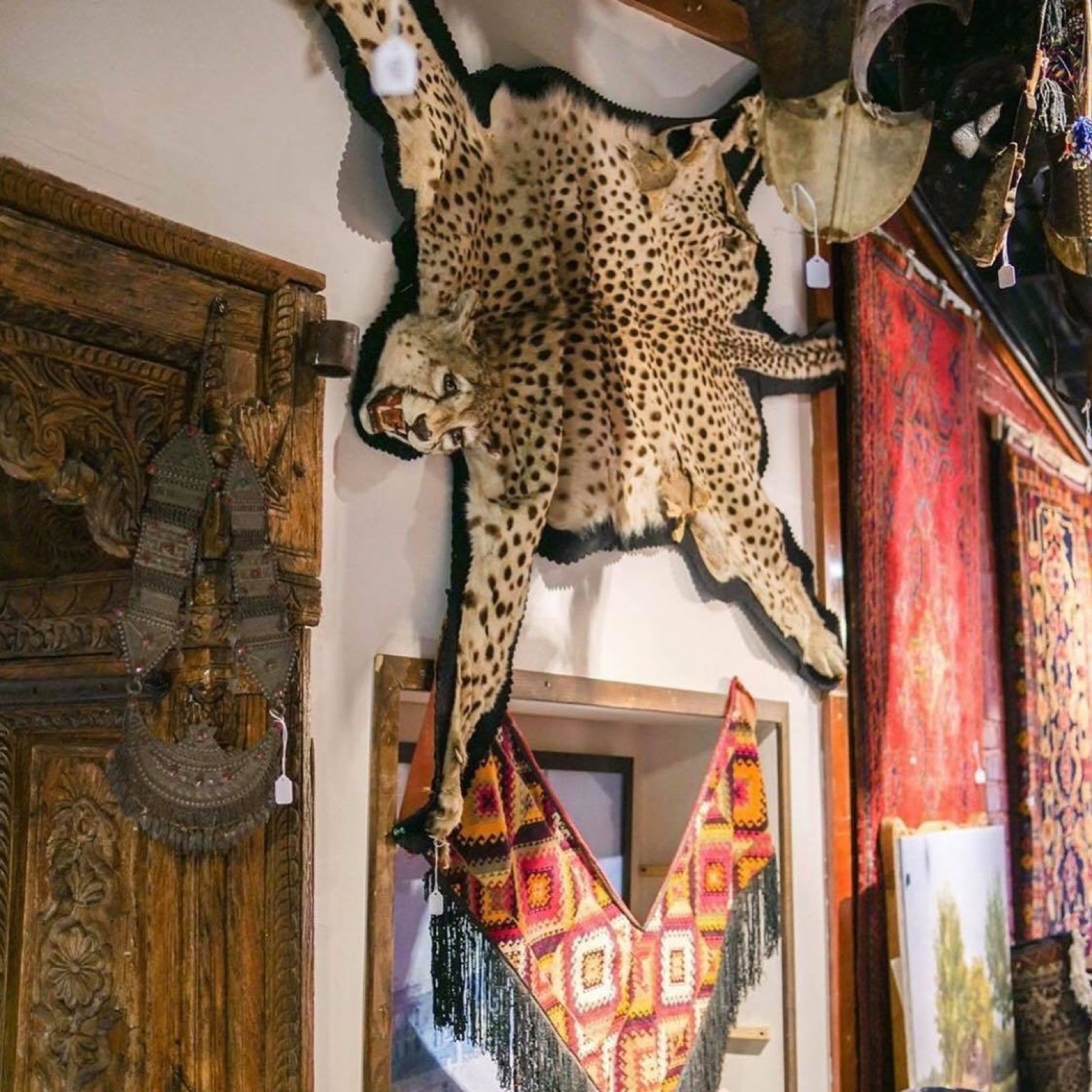 A room of the gallery hung with rugs and mounted textiles