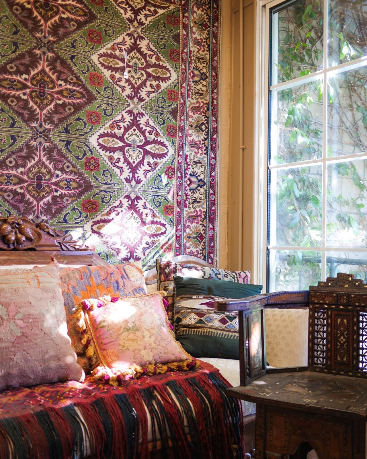 Inside Khyber Pass Gallery — rugs, textiles and antiques by the window